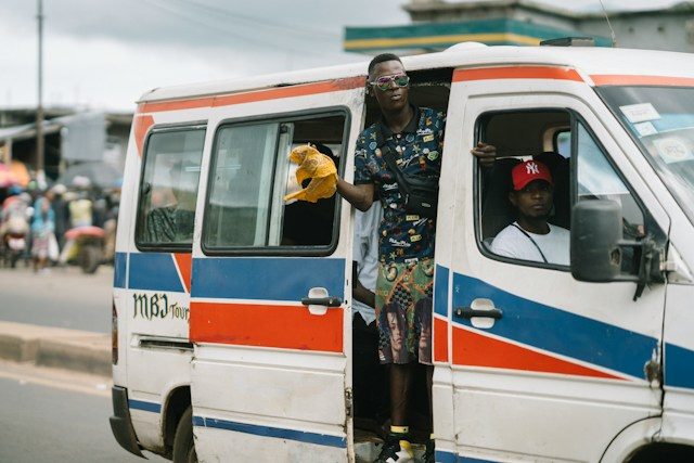 Young man leaning out of a trotro minibus